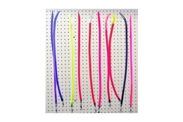 A pegboard displays eight colorful, semi-flexible plastic rods in a mix of pink, yellow, and blue, organized in a vertical arrangement.