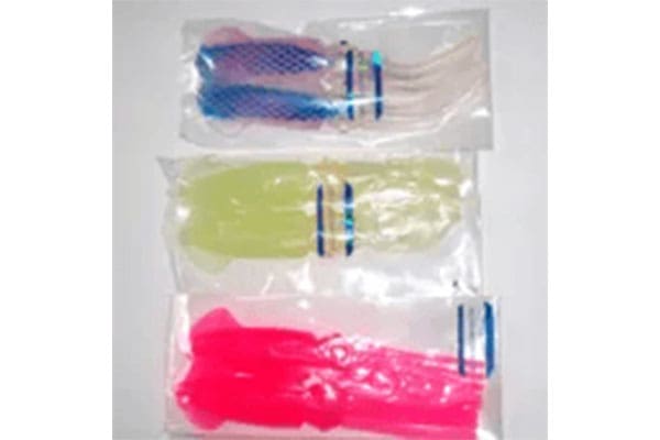 Three bags of colorful plastic fishing lures. The top bag contains blue and purple lures, the middle bag has yellow-green lures, and the bottom bag contains bright pink lures.