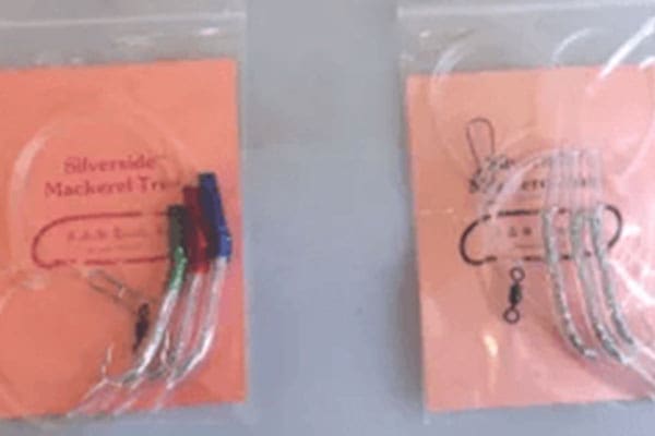 Two packs of fishing tackle labeled "Silverside Mackerel Trace" in plastic bags against a light background. They contain hooks and colored line components.