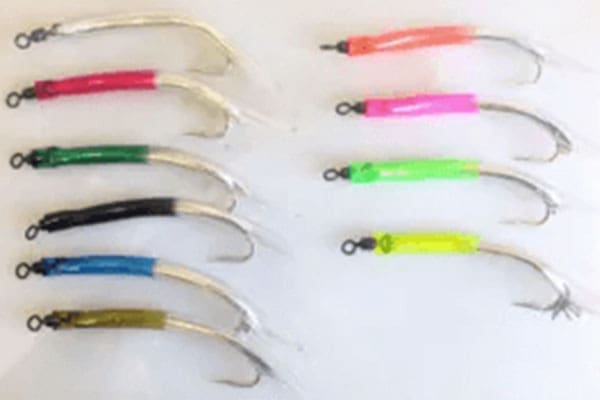 Ten colorful fishing hooks arranged in two vertical columns against a plain white background. Each hook is partially wrapped with different colored materials.