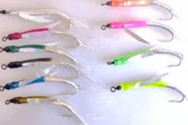 A set of ten colorful fishing hooks with reflective strips arranged in two rows on a white background.